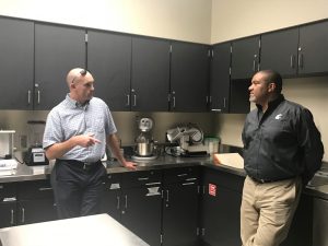 Two men talking in a classroom
