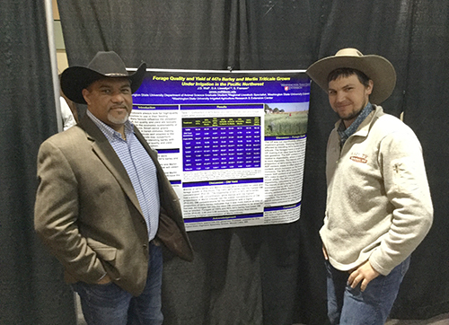 The Dean, left, and student, right, talk across a research poster.
