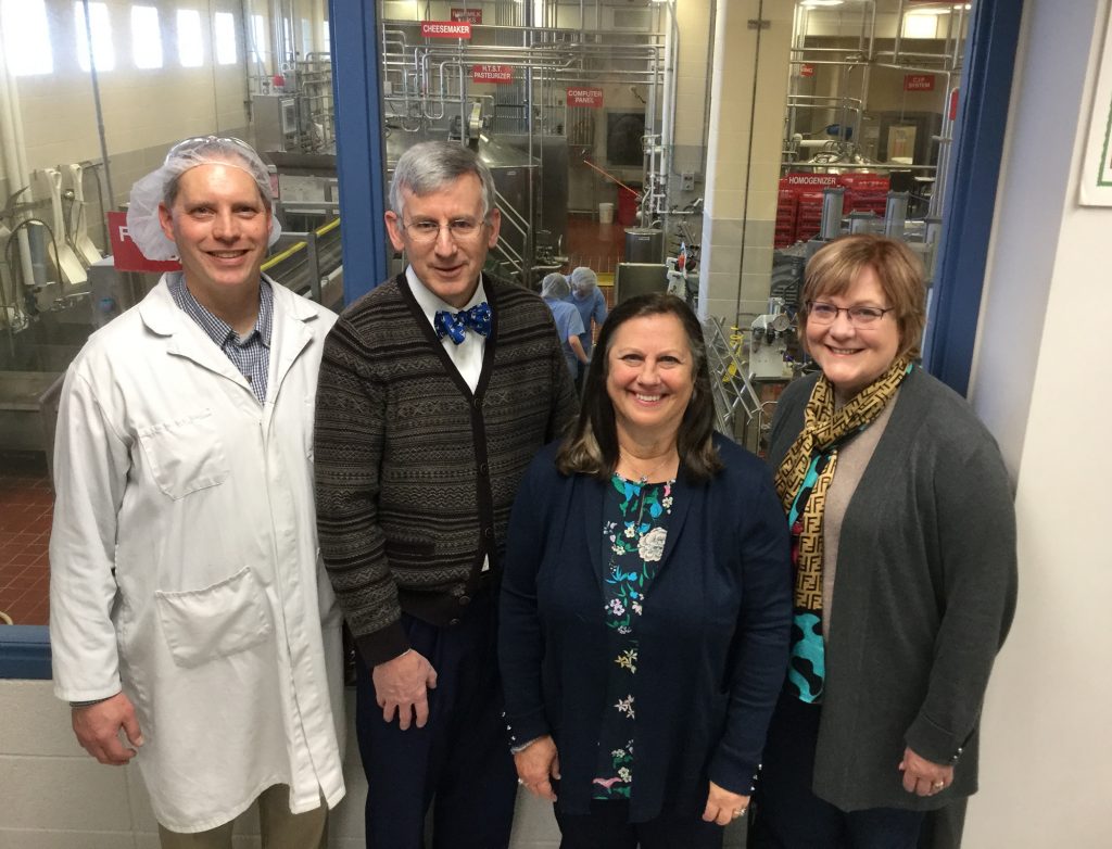 Group in front of window onto creamery workroom.