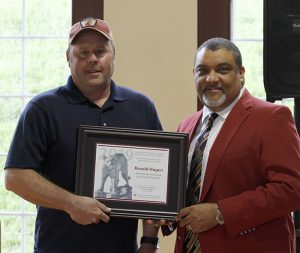 Nugen, left, with Wright, both holding award.