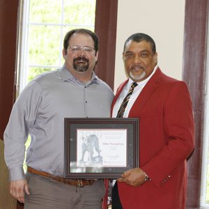 Pumphrey holding award with the Dean.