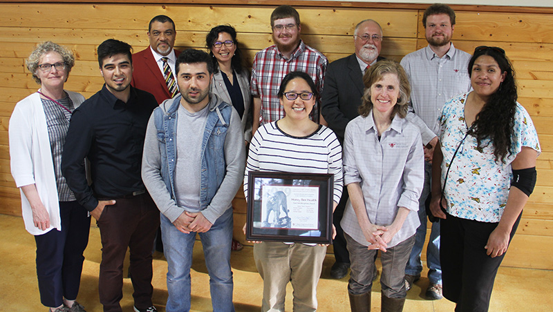 Group photo of team and faculty with award certificate.