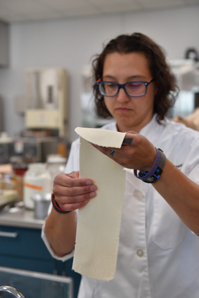 Kiszonas holding a roll of dough