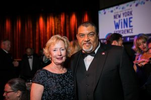 To people posing in formal wear at gala event.