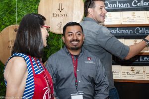 Winemakers pausing for a laugh at event.