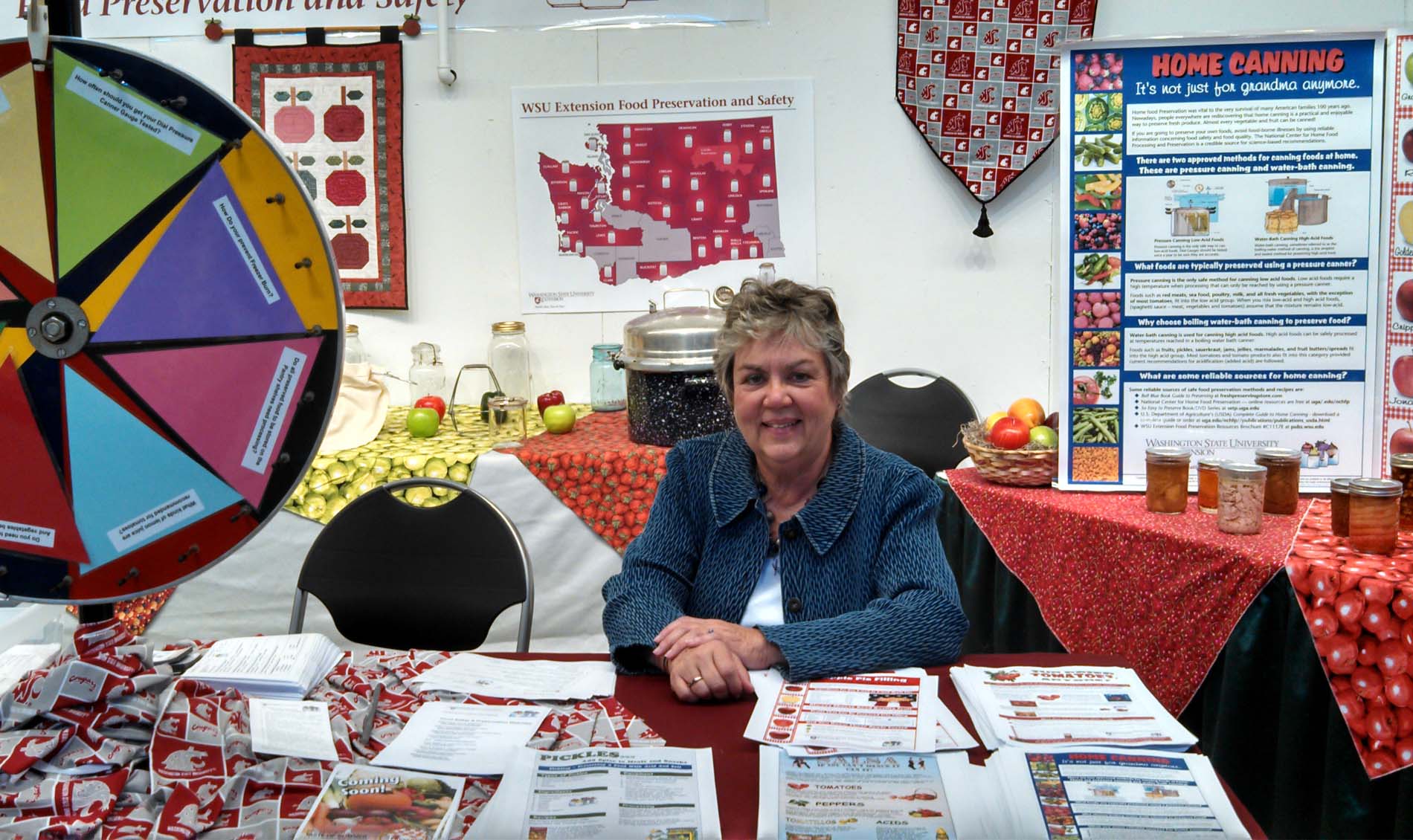 Margaret Viebrock sitting at a desk during tabling event.