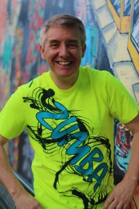 Yarbough smiles, arms on hips.