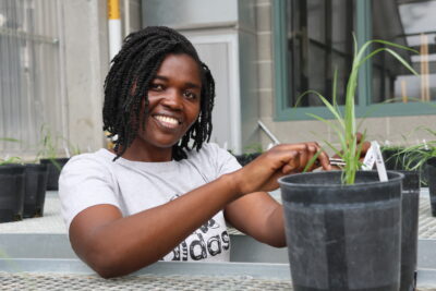 Raissa Fon handling potted ryegrass