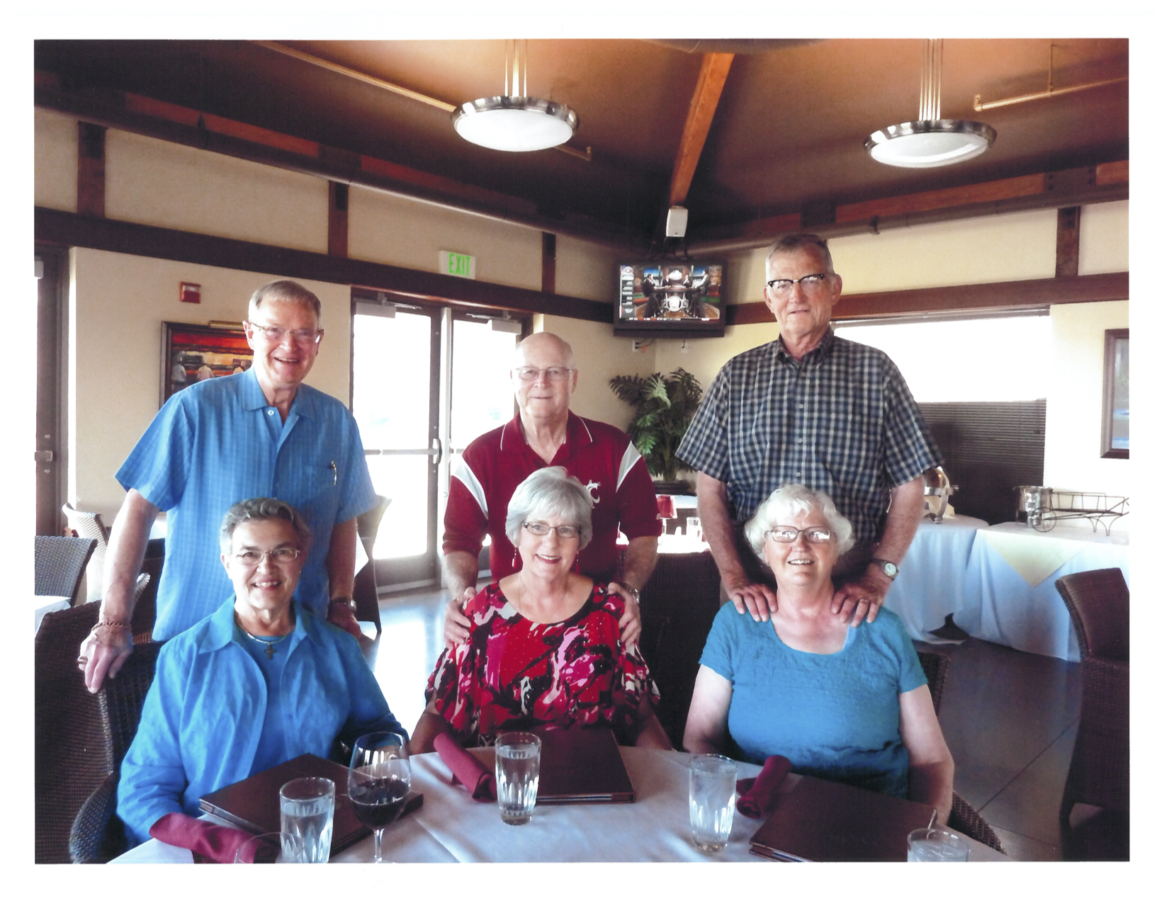 Three couples sitting together at a table.