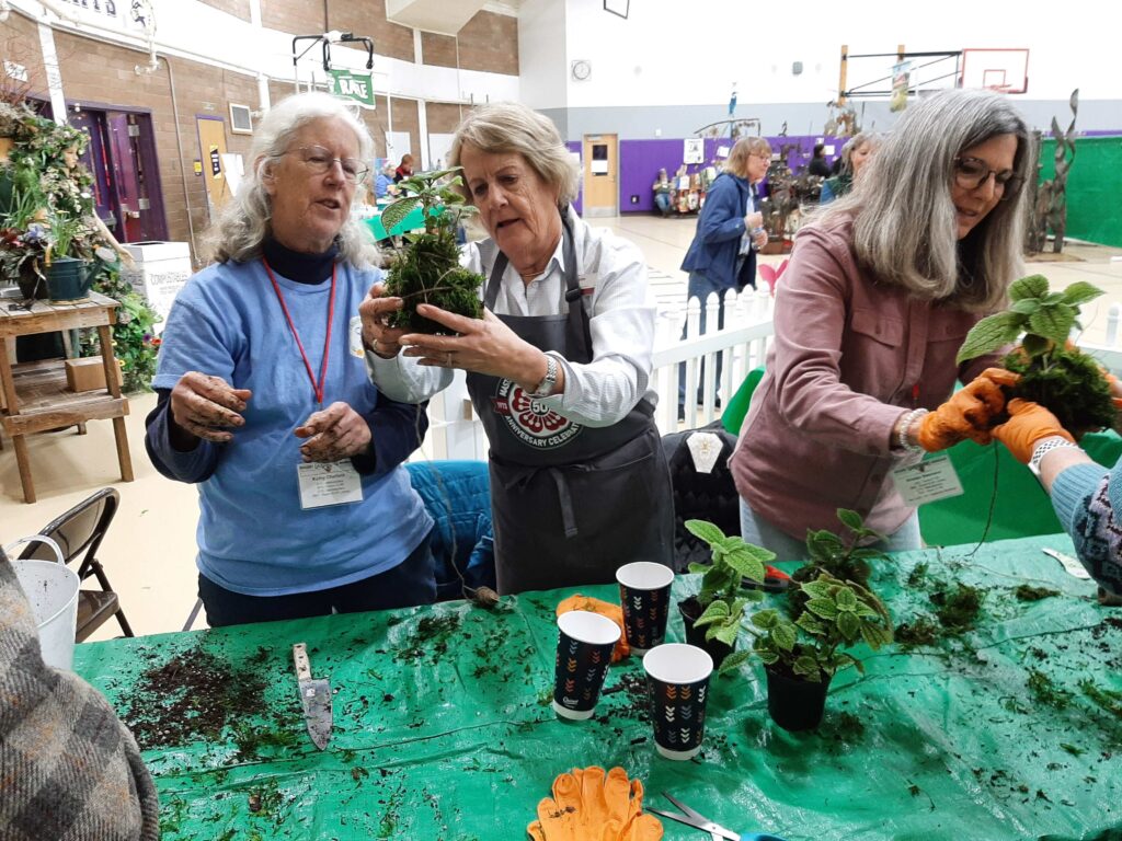 Volunteer gardener booth in gymnasium -