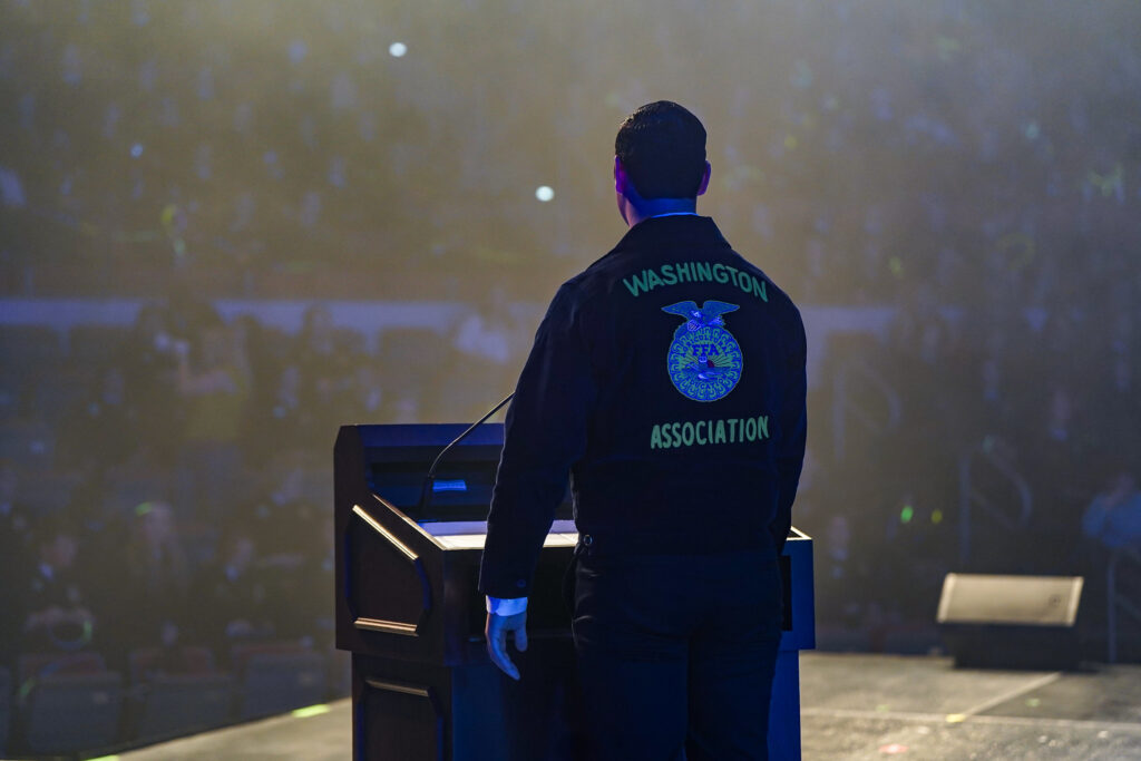 A Washington FFA member addresses this year's convention-goers from the podium.