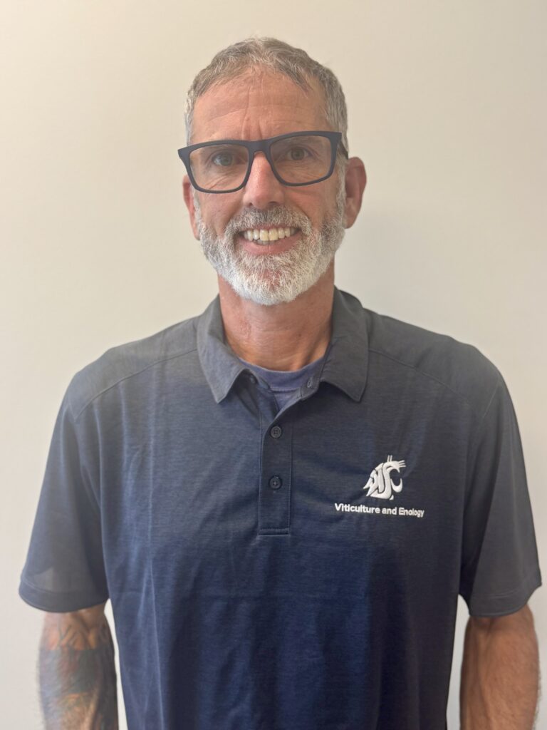 Sam Keirsey, wearing a gray polo with the WSU logo and the words "Viticulture and Enology."