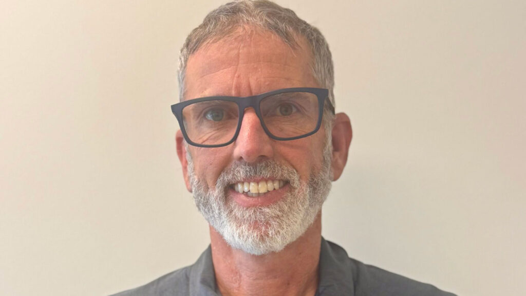 Sam Keirsey, wearing a gray polo with the WSU logo and the words "Viticulture and Enology."