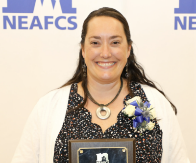 Kayla Wells-Yaokum portrait photo holding award from NEAFCS.