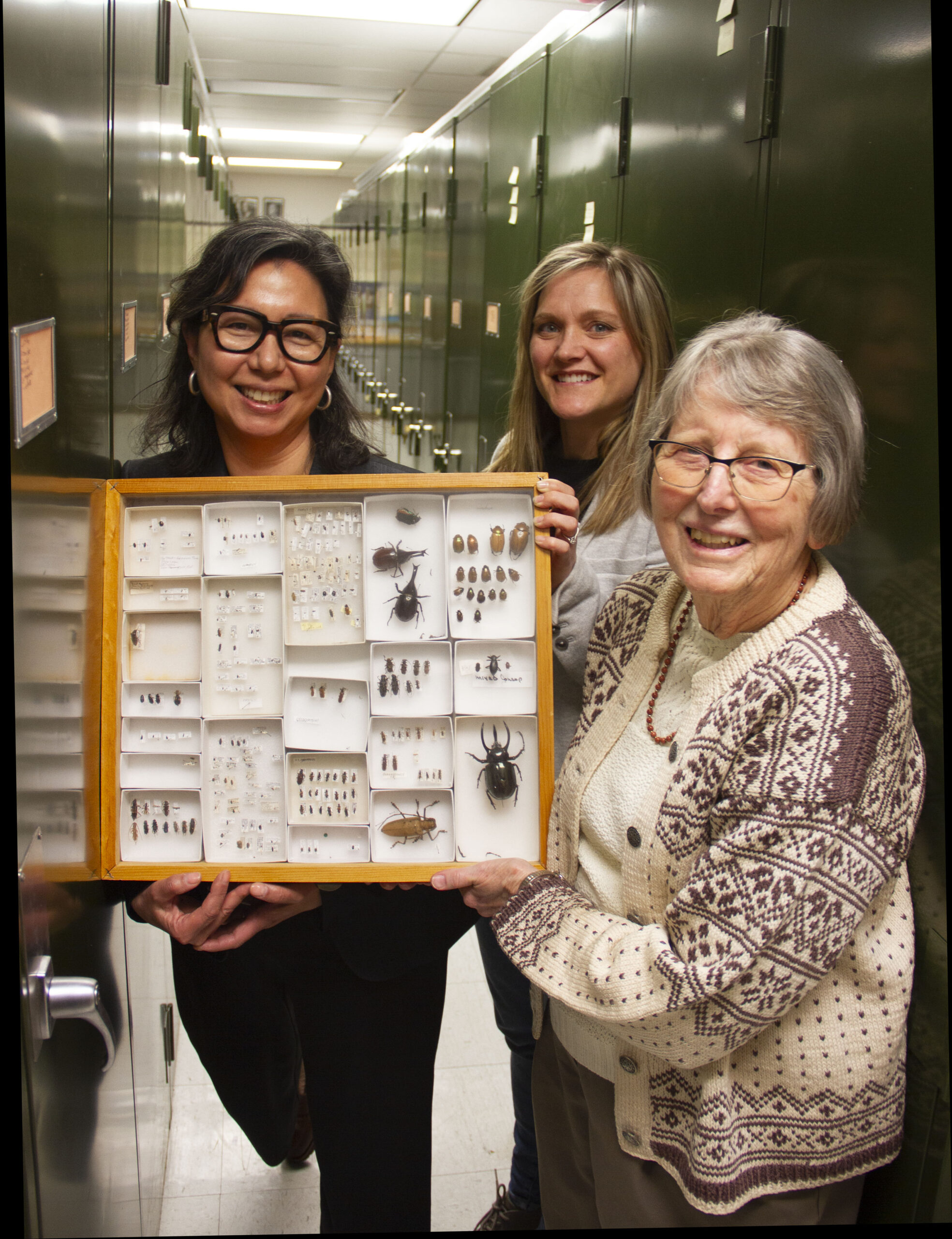 Laura, Elizabeth, and Alice holding bug collection.