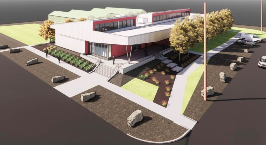  Architect's illustration showing an overhead view of a red and white research building with attached greenhouses, trees and landscaping. A row of overhead windows tops the roof.