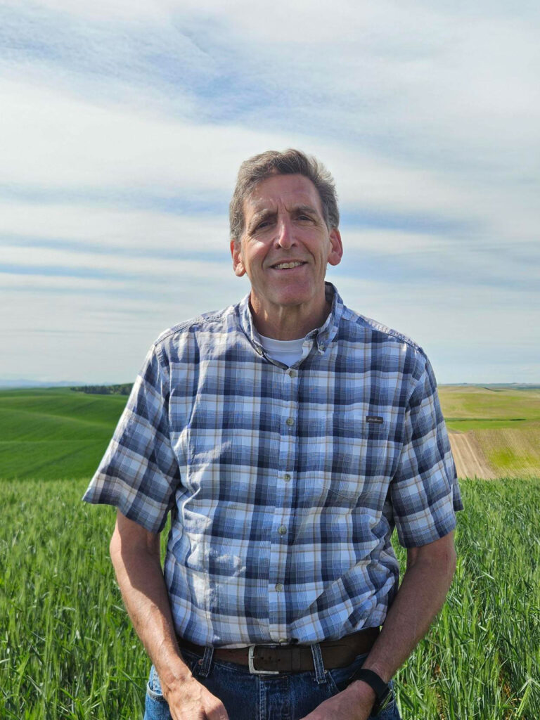 Scot Hulbert stands in a field.