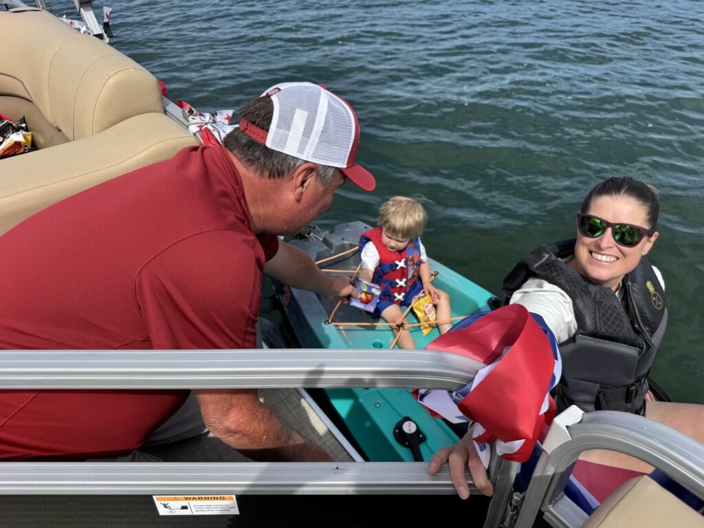 Boater handing out apple in boat party