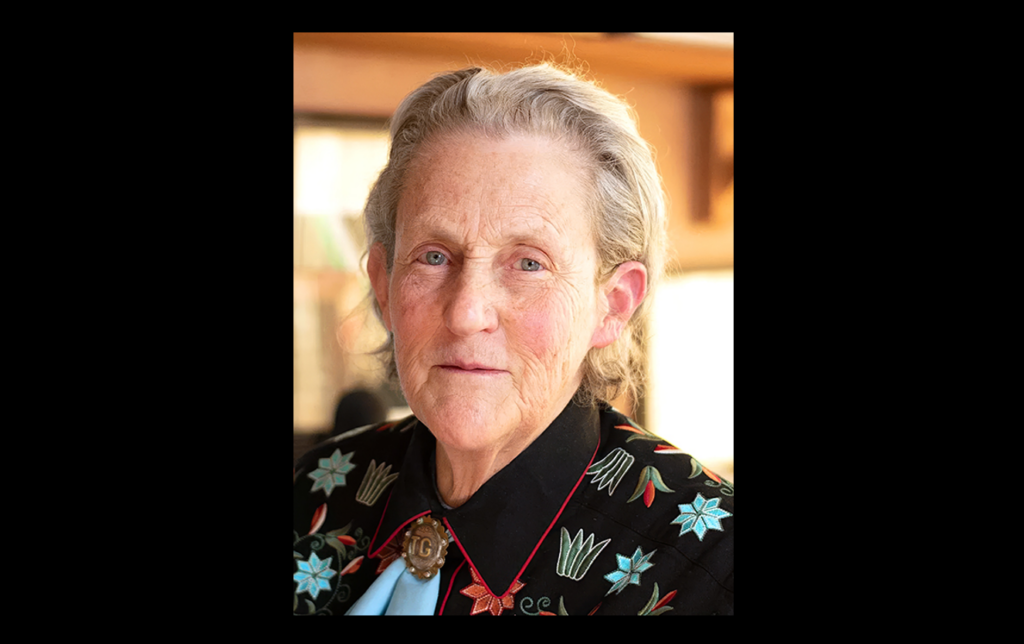 Portrait of Temple Grandin on a black background.