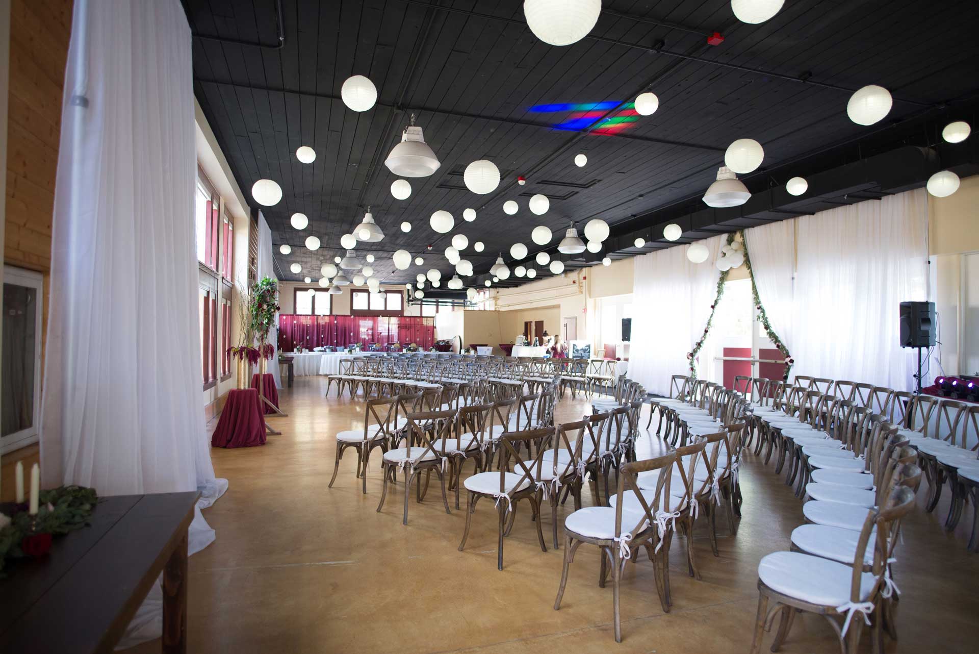 Ensminger Pavilion set up for a wedding with chairs, hanging lights, and an altar.