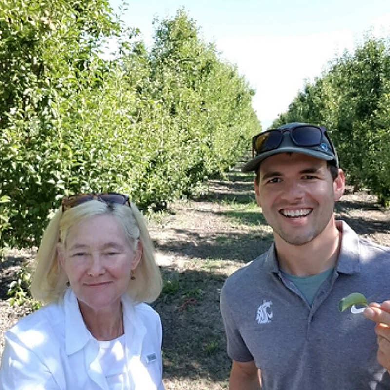 Betsy Beers and Louie Nottingham in a Northern California pear orchard.