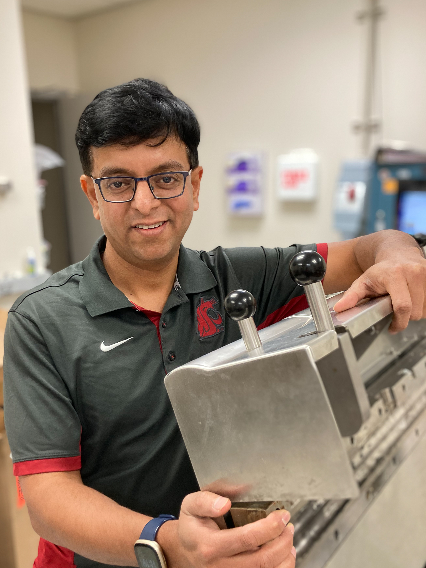 Person holding an extruder machines in a lab.
