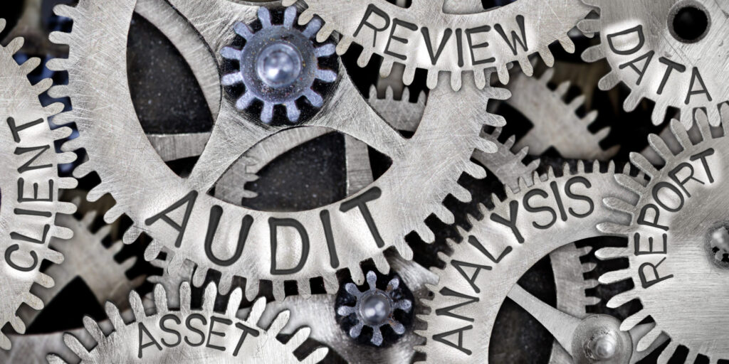 Mechanical gears with words audit, review, data, analysis, report, asset, and client.