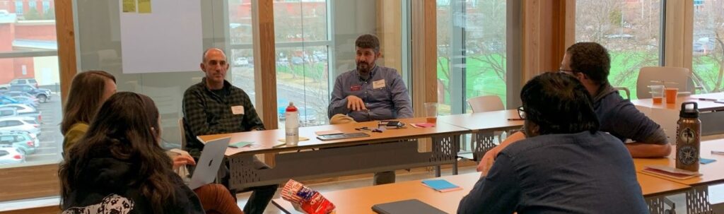 A group of six at a roundtable discussion.