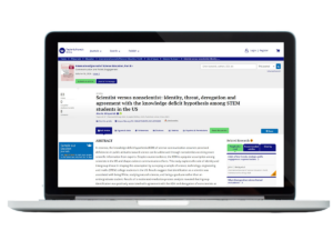 Laptop with illegible screenshot of publication superimposed.