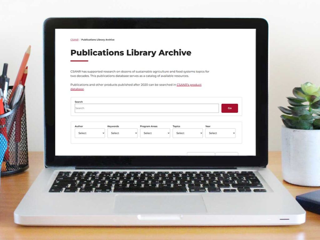 Screenshot of publications library archive page superimposed on laptop image.