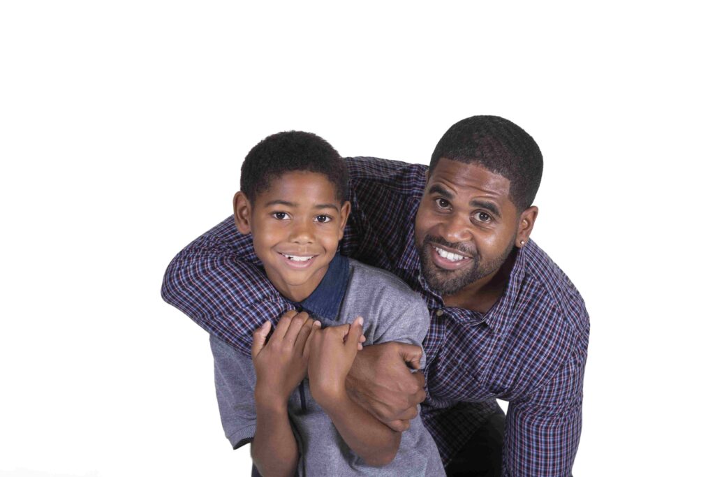 Father and son embracing.