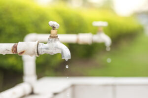 Water dripping from faucet in an outdoor produce packing area