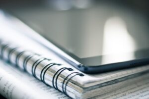 A tablet on top of notebooks