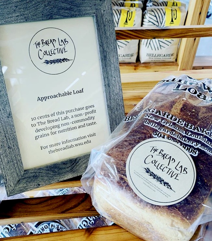 Loaf of bread next to a bread lab collective sign.