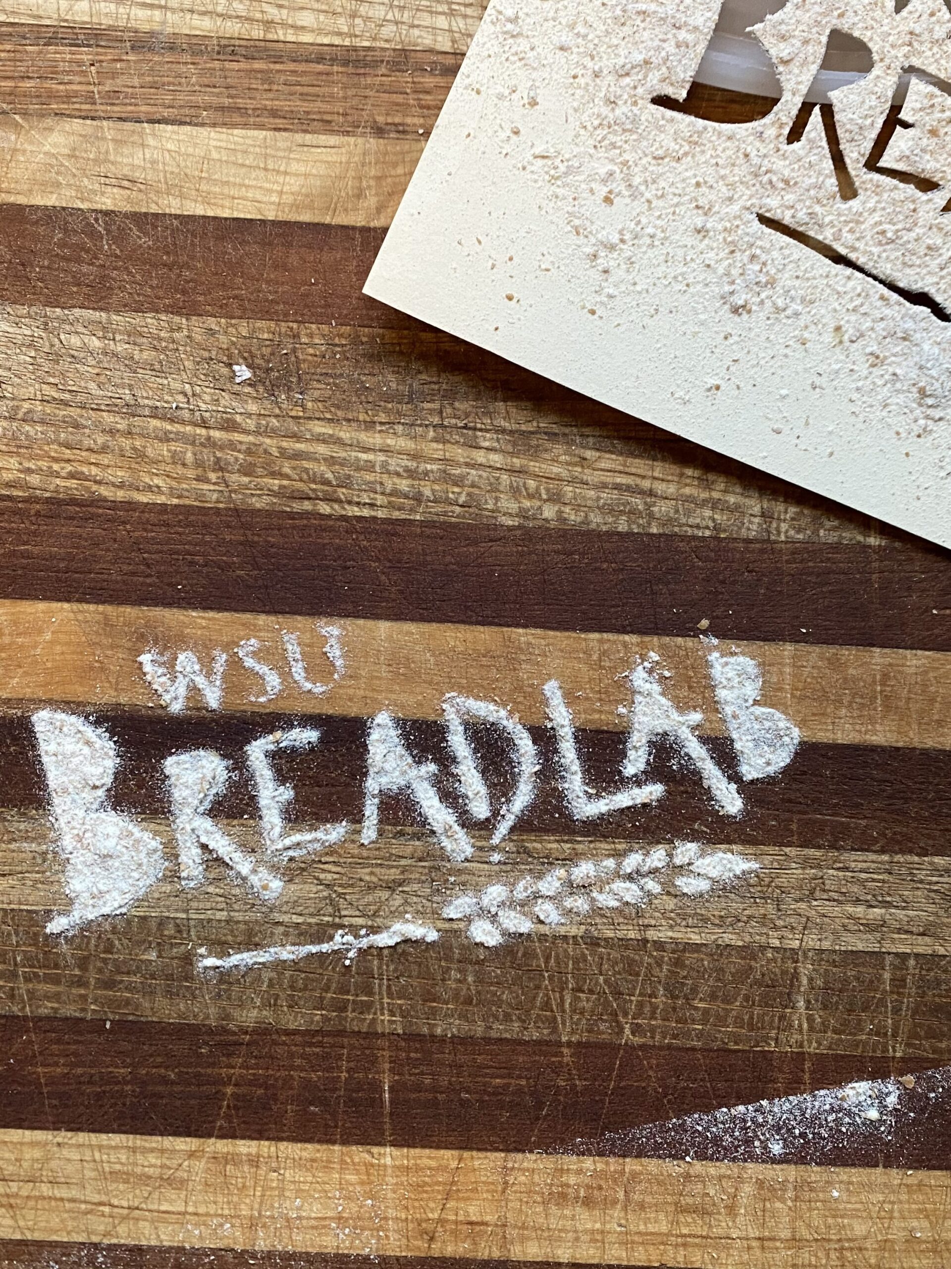 WSU Breadlab written on a wooden block cutting board.