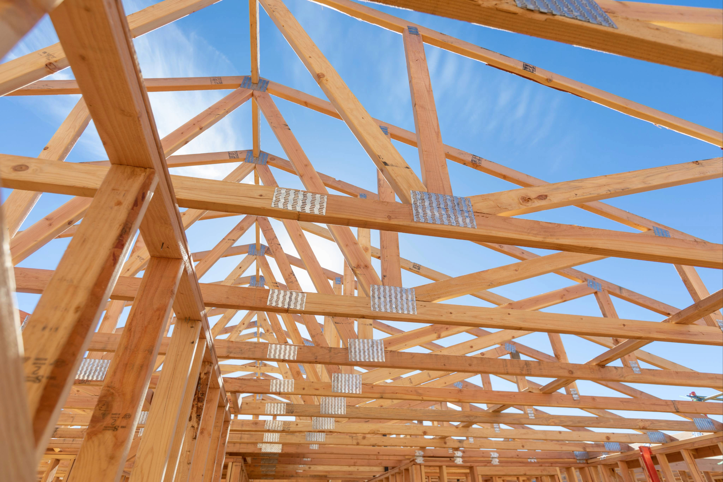 An image of a residential construction site with blue sky in the background.