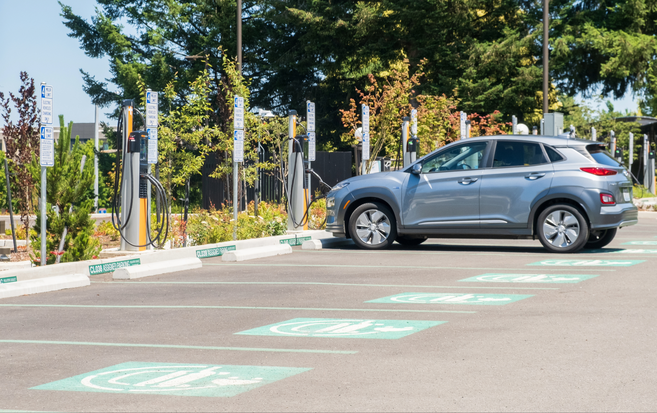An electric vehicle charges at a charging station in a parking lot in Olympia, Washington.