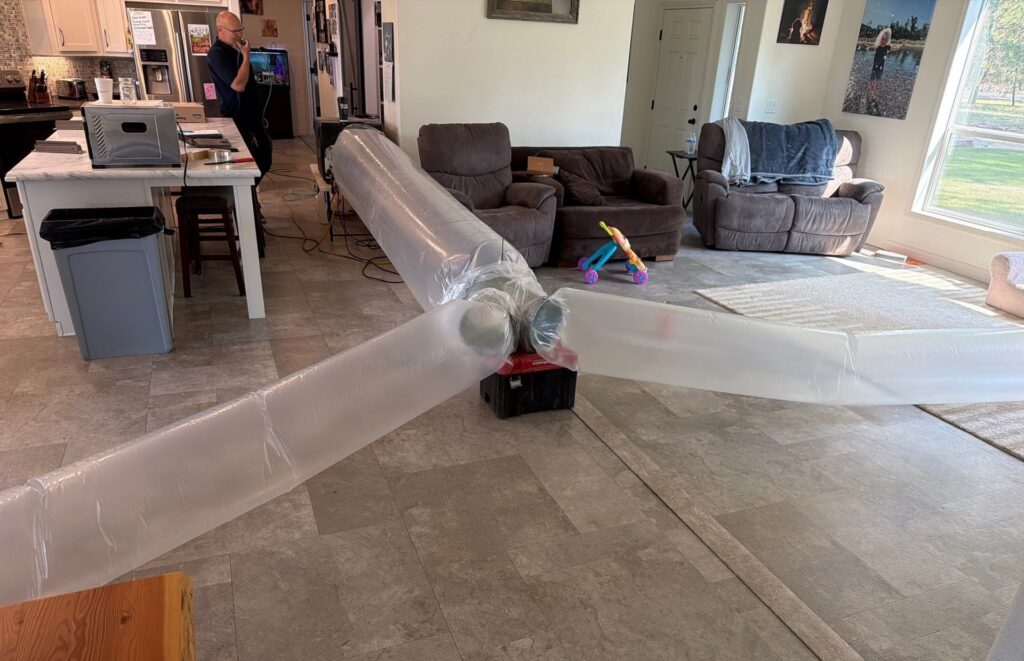 Plastic inflated tubes blow aeroseal insulation throughout a residence in Washington