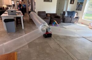 Plastic inflated tubes blow aeroseal insulation throughout a residence in Washington