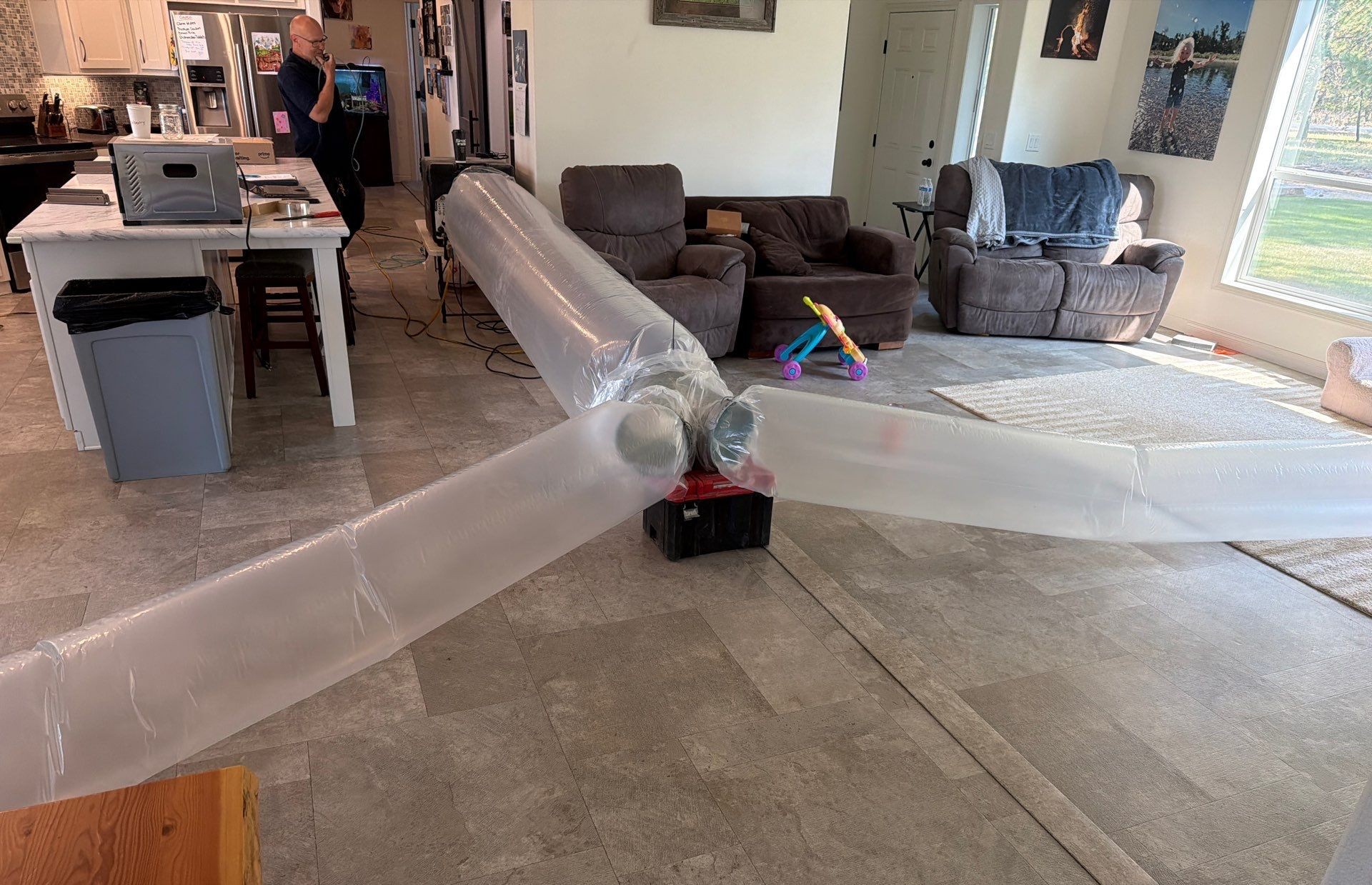 Plastic inflated tubes blow aeroseal insulation throughout a residence in Washington