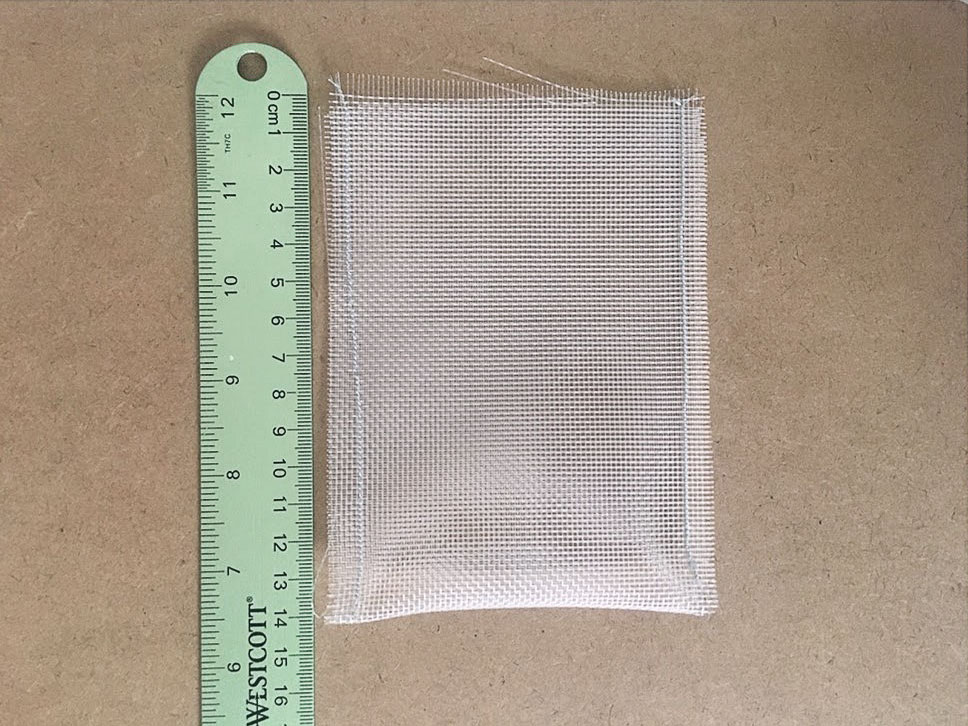 Sewn mesh bag; ruler showing 14cm length.