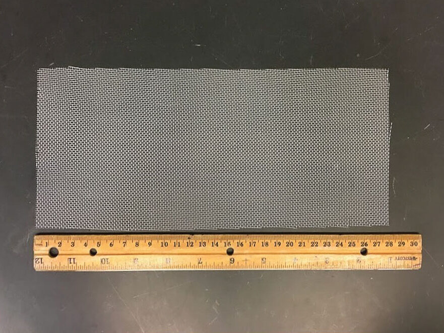 Rectangle of mesh fabric with ruler showing 28 cm length.