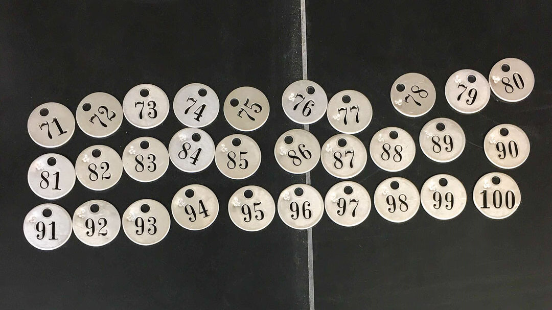 Round aluminum tags (numbered "71" to "100").