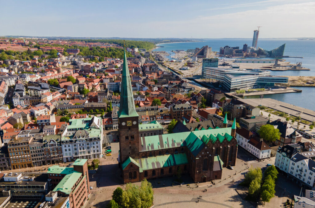 Panoramic shot of trees and buildings on the waterfront in the city of Aarhus, Denmark.