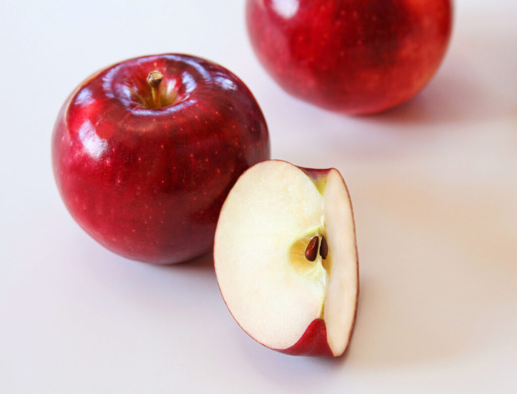 Red apples, whole and sliced.