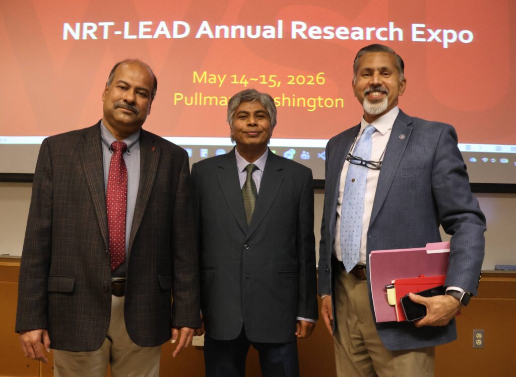 Raj stands with two other men in front of a screen that reads NRT-LEAD Annual Research Expo, May 14-15, 2026, Pullman, Washington.