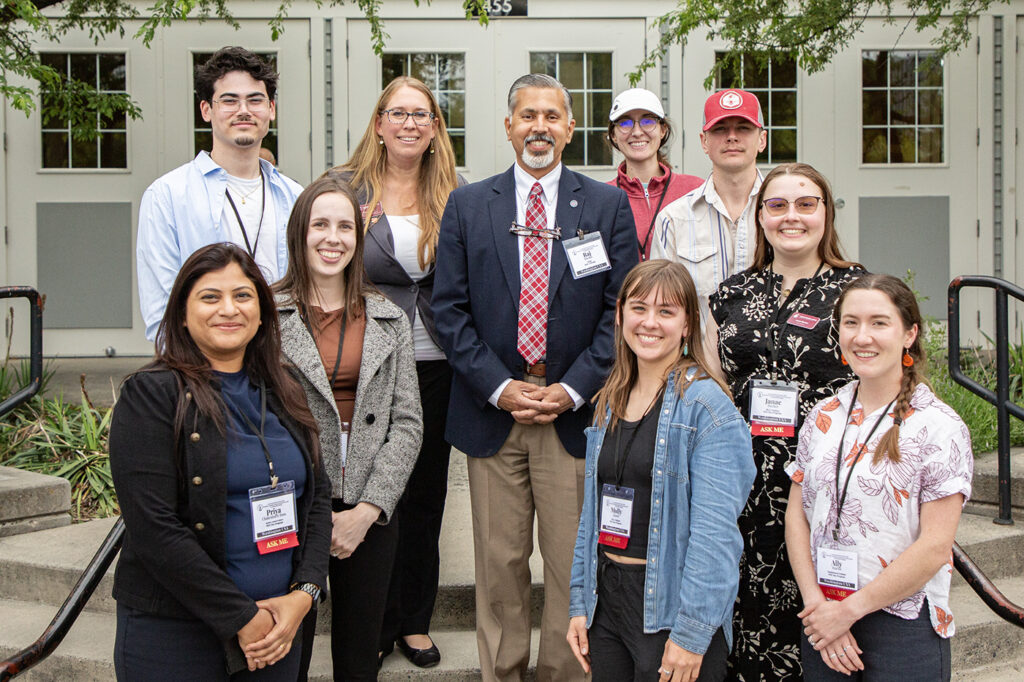 A group of 10 people stands outside of Ensminger Pavilion.