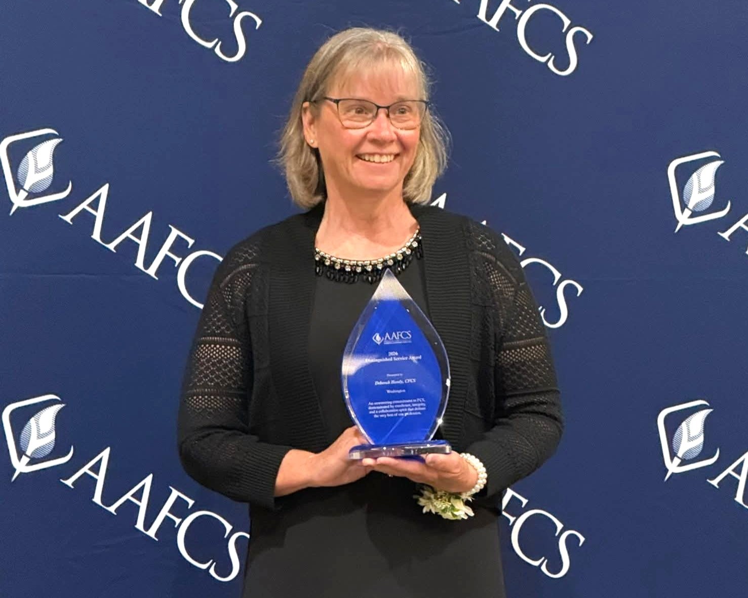 Debbie Handy holding award.