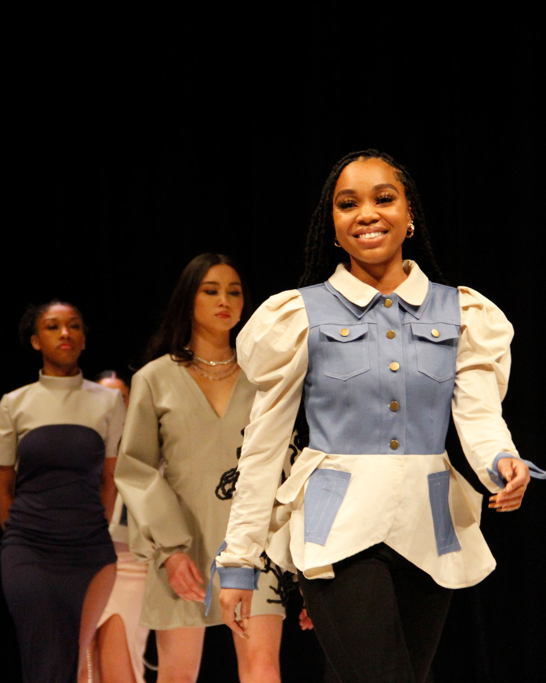 Females student on the runway at AMDT fashion show.