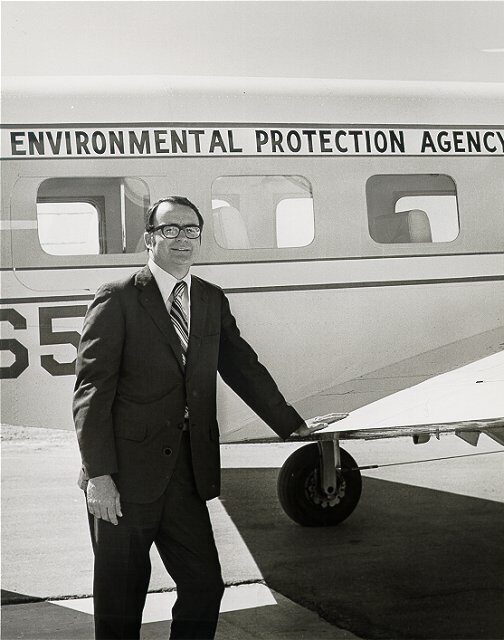 Bill Ruckelshaus standing in front of a plane.